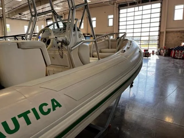 Slide: The Image of 1998 Nautica RIB 18 Widebody inflatable boat in a warehouse. - 7