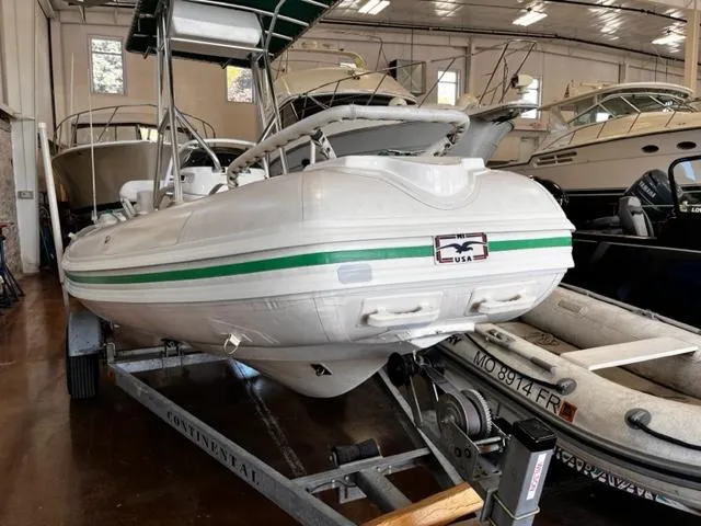 Slide: The Image of 1998 Nautica RIB 18 Widebody inflatable boat on trailer in indoor storage. - 8