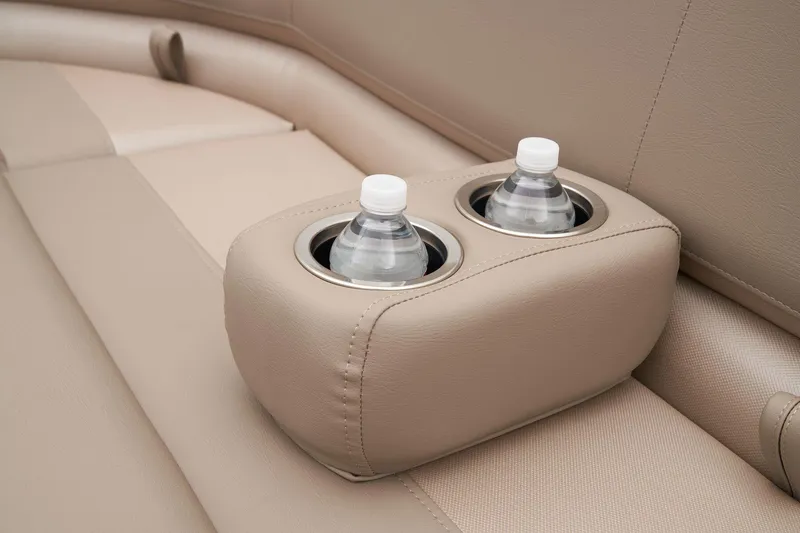 Slide: The Image of 2024 Ranger Reata 200C beige leather seats with dual cup holders. - 18