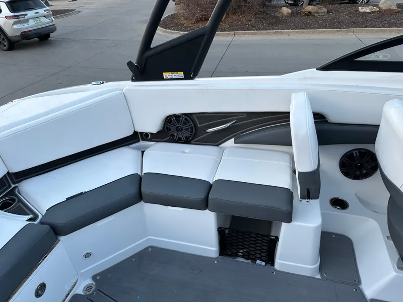 Slide: The Image of 2024 Tahoe 210 S boat interior with white and gray seating. - 10