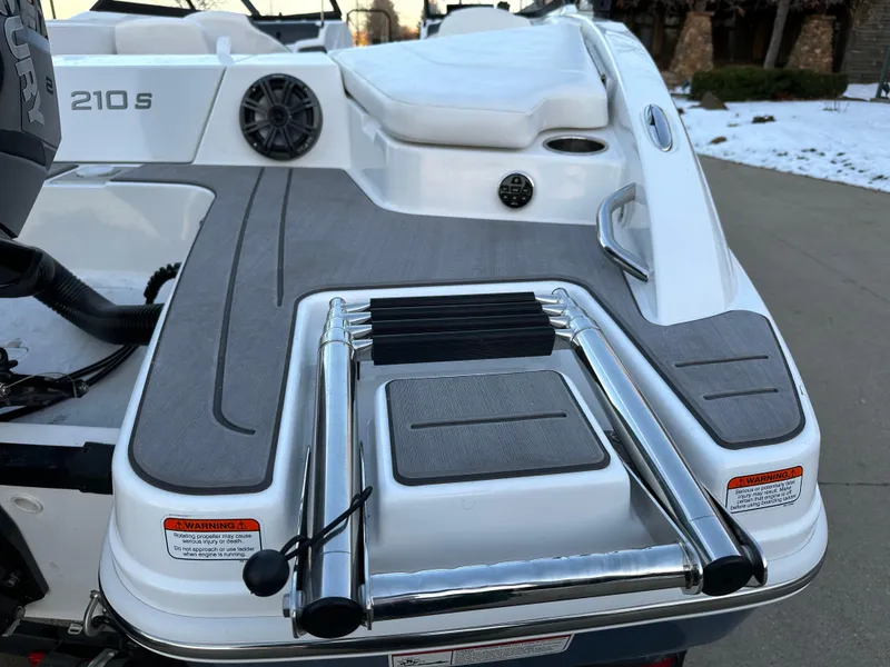 Slide: The Image of 2024 Tahoe 210 S boat swim platform with ladder and speaker. - 14