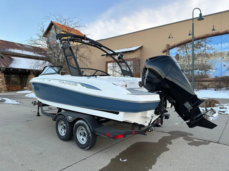 Slide: The Image of 2024 Tahoe 210 S boat on trailer, outdoor setting. - 2