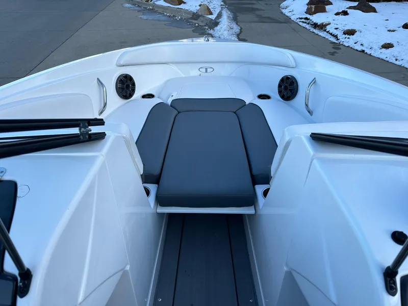 Slide: The Image of 2024 Tahoe 210 S boat interior with cushioned seating and speakers. - 4