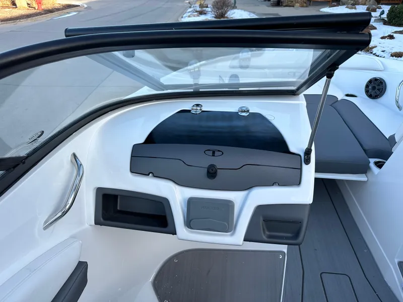Slide: The Image of 2024 Tahoe 210 S boat interior with windshield and seating area. - 6