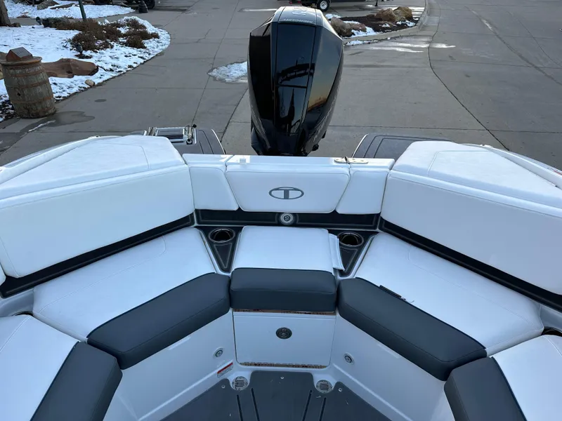 Slide: The Image of 2024 Tahoe 210 S boat with white and gray seating, rear view of outboard motor. - 8