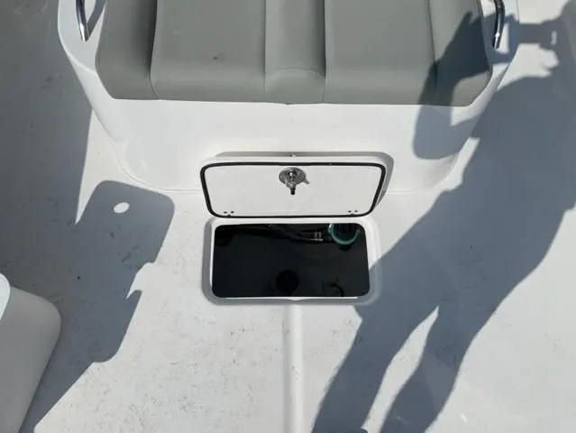 Slide: The Image of 2024 Cape Horn 31T boat storage compartment with gray cushioned seat. - 12