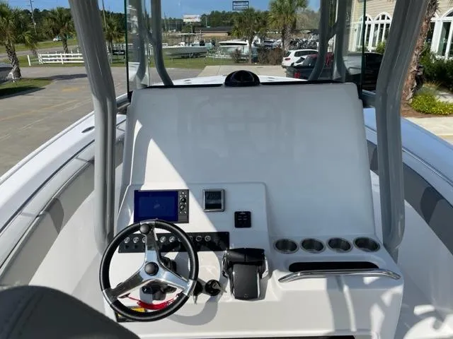 Slide: The Image of 2024 Cape Horn 31T boat console with steering wheel, navigation system, and cup holders. - 17