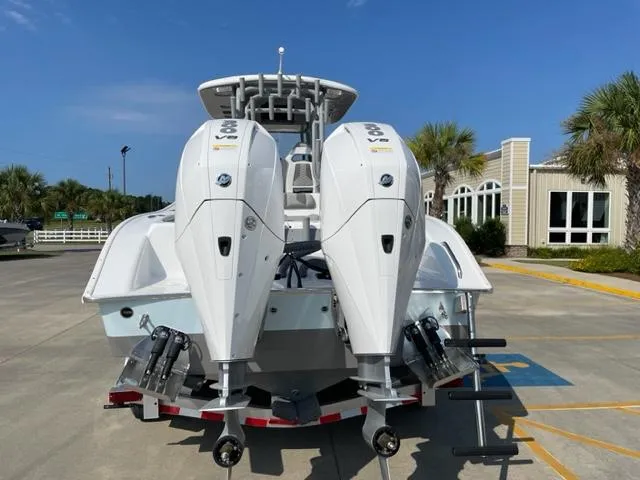 Slide: The Image of 2024 Cape Horn 31T boat with twin outboard engines in a marina. - 2