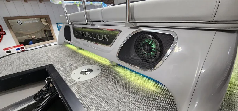 Slide: The Image of 2024 Bennington 25QXSBA boat interior with illuminated speakers and stylish seating. - 15
