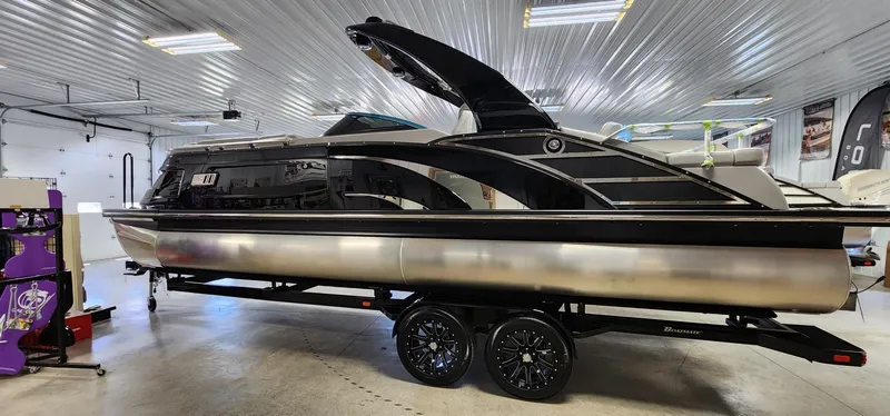 Slide: The Image of 2024 Bennington 25QXSBA pontoon boat in a showroom. - 17