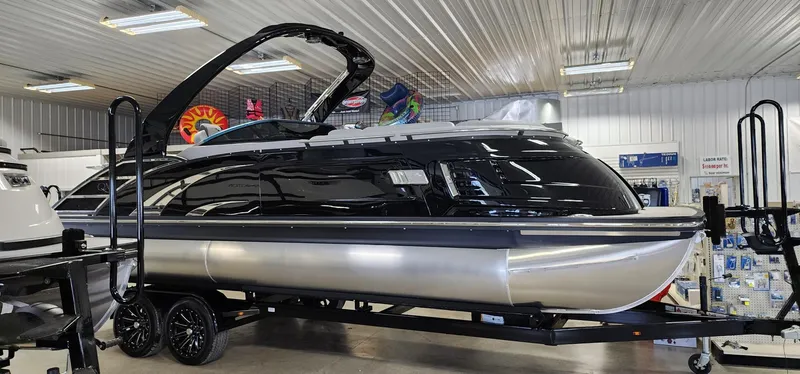 Slide: The Image of 2024 Bennington 25QXSBA pontoon boat in showroom. - 2