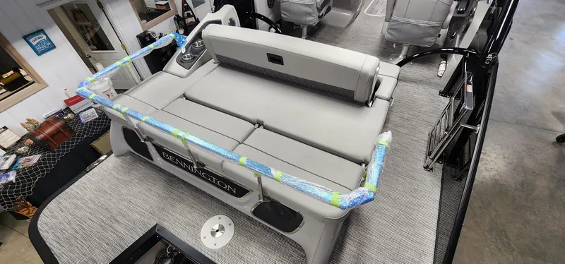 Slide: The Image of 2024 Bennington 25QXSBA pontoon boat with gray seating and deck. - 7