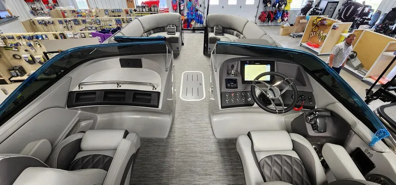 Slide: The Image of 2024 Bennington 25QXSBA boat interior with modern dashboard and seating. - 9