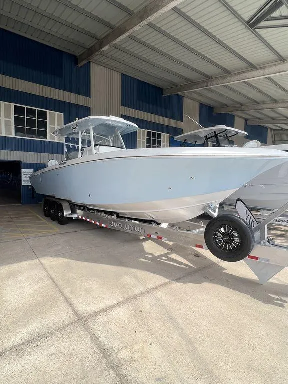 Slide: The Image of 2024 Fountain 34 TE boat on a trailer in a covered storage area. - 1