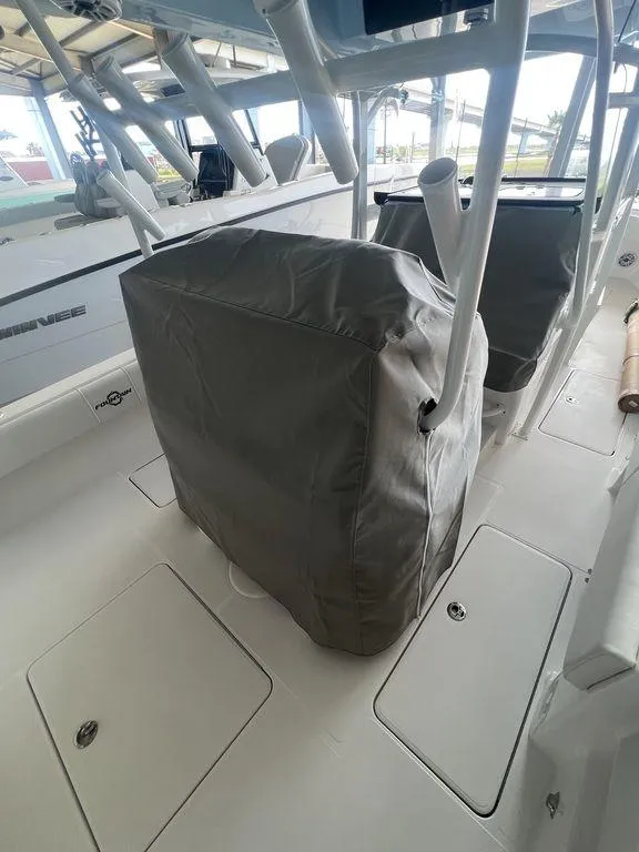 Slide: The Image of 2024 Fountain 34 TE boat interior with covered seating and storage compartments. - 11