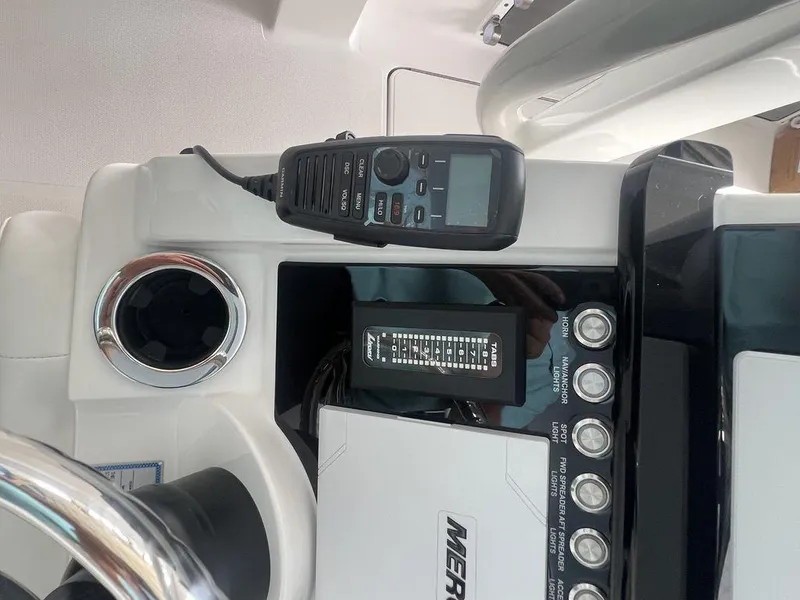 Slide: The Image of Control panel of 2024 Fountain 34 TE boat with radio and cup holder. - 13