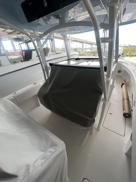 Slide: The Image of 2024 Fountain 34 TE boat interior with covered console and seating. - 15