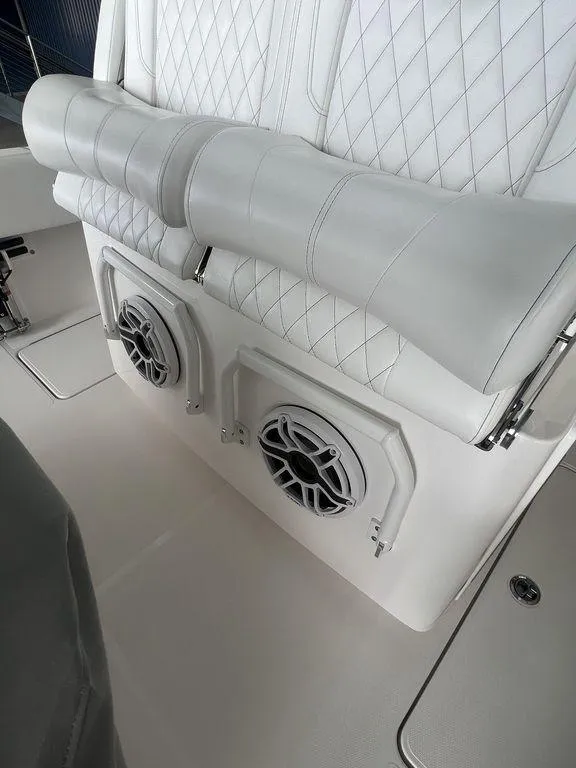Slide: The Image of 2024 Fountain 34 TE boat with white quilted seats and built-in speakers. - 22