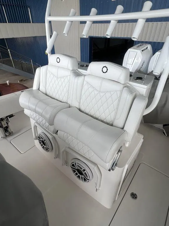Slide: The Image of 2024 Fountain 34 TE boat with white leather seating and built-in speakers. - 24