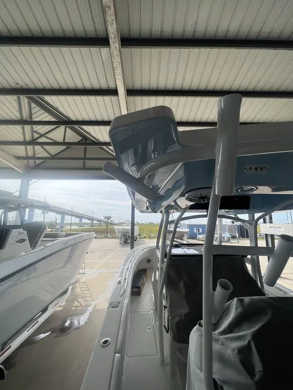 Slide: The Image of 2024 Fountain 34 TE boat under a covered dock. - 28