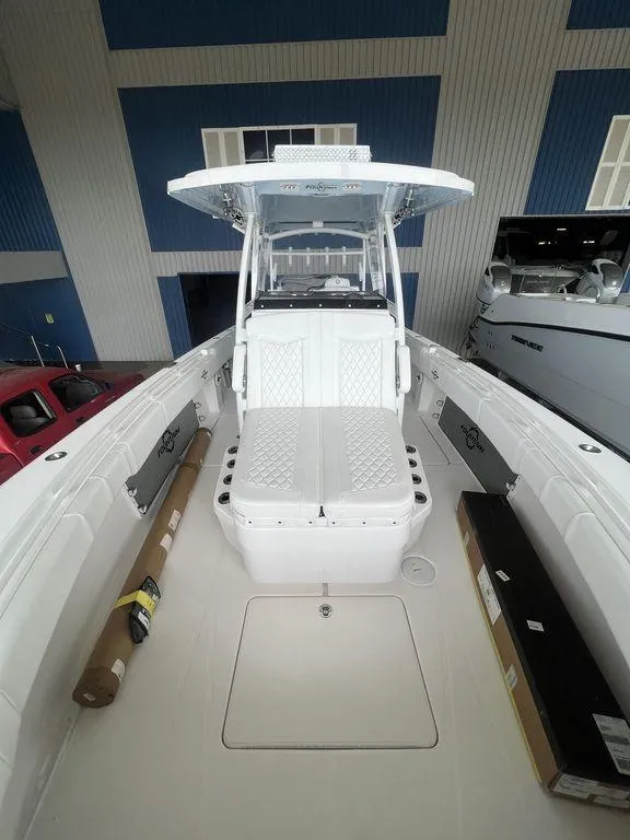 Slide: The Image of 2024 Fountain 34 TE boat with center console and seating, docked indoors. - 29