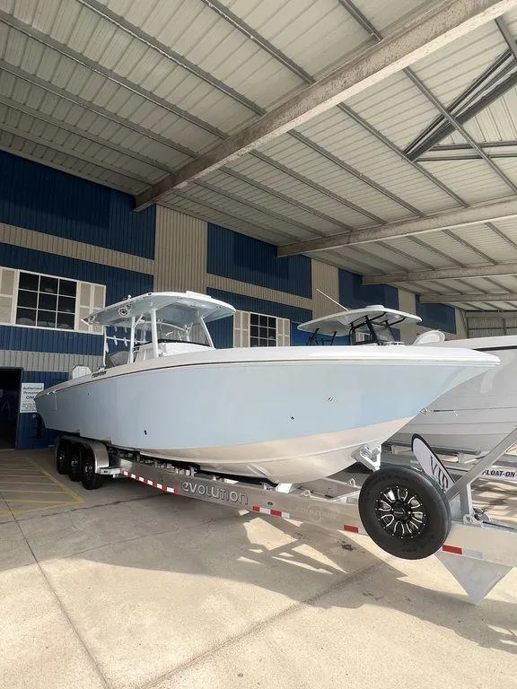 Slide: The Image of 2024 Fountain 34 TE boat on a trailer in a covered storage area. - 3