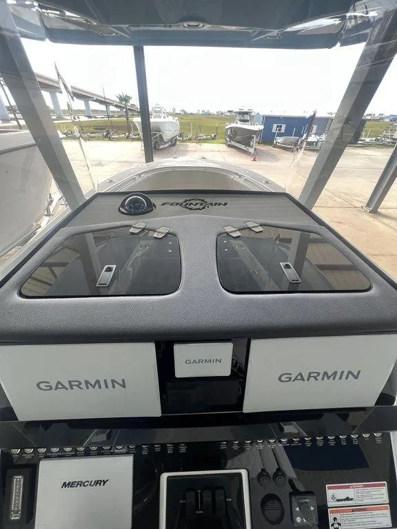 Slide: The Image of 2024 Fountain 34 TE boat dashboard with Garmin navigation systems. - 30