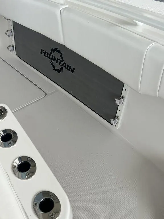 Slide: The Image of 2024 Fountain 34 TE boat interior with rod holders and logo. - 33