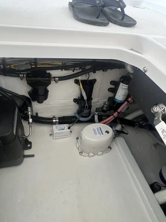 Slide: The Image of 2024 Fountain 34 TE boat engine compartment with mechanical components and wiring. - 35