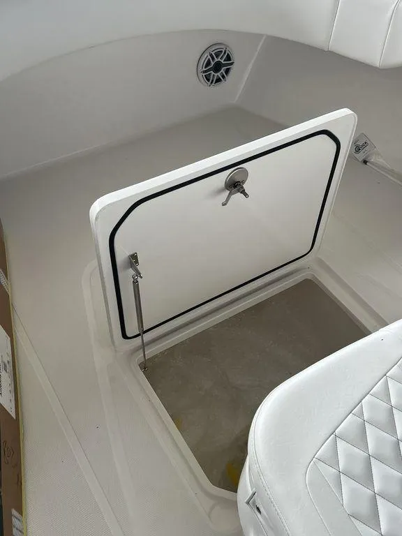Slide: The Image of 2024 Fountain 34 TE boat storage compartment with open hatch and cushioned seating. - 36