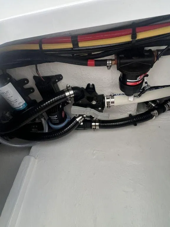 Slide: The Image of 2024 Fountain 34 TE boat engine compartment with wiring and hoses. - 38