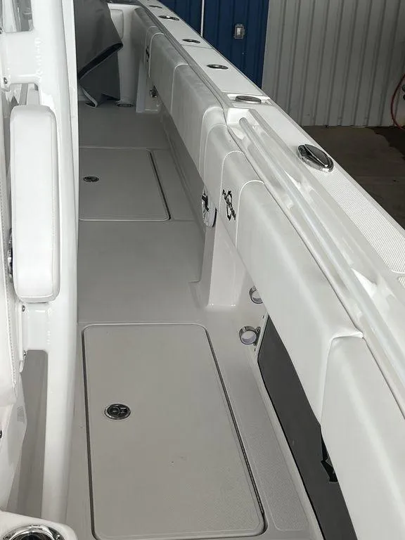 Slide: The Image of 2024 Fountain 34 TE boat interior with storage compartments and rod holders. - 43