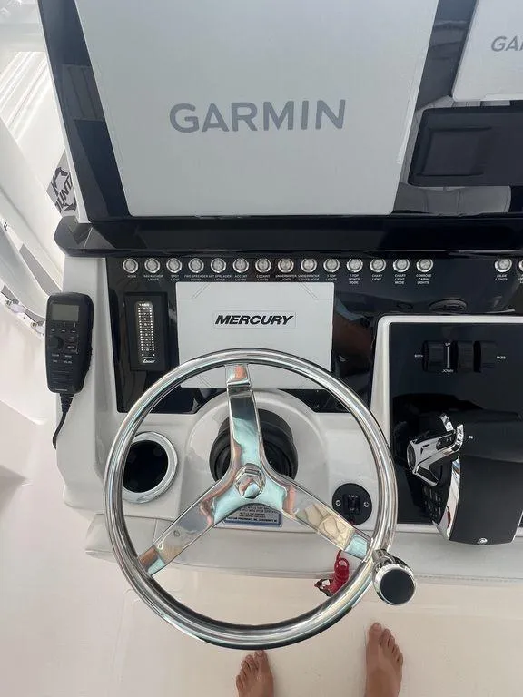 Slide: The Image of 2024 Fountain 34 TE boat dashboard with Garmin and Mercury controls. - 9