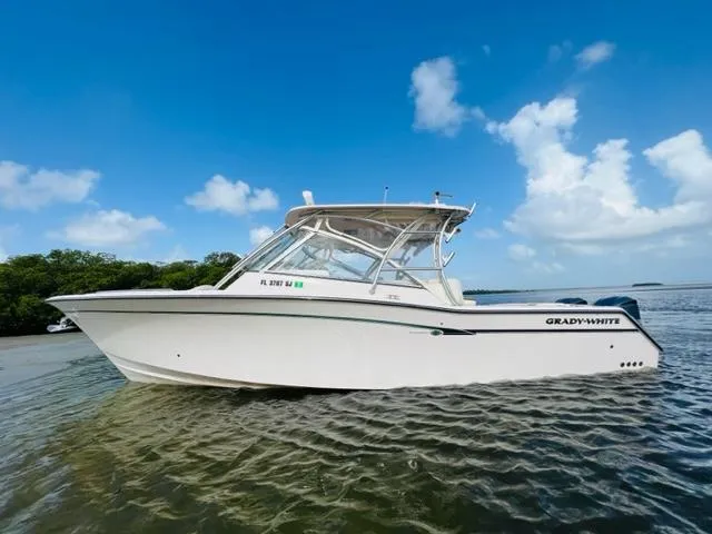 Slide: The Image of 2014 Grady-White Freedom 335 boat on calm water under a clear blue sky. - 1