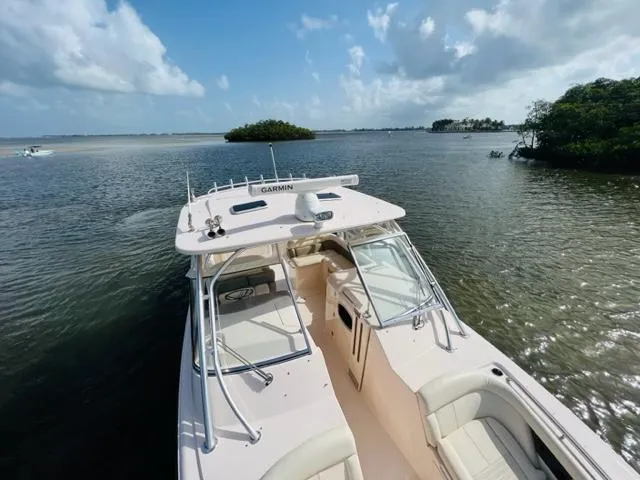 Slide: The Image of 2014 Grady-White Freedom 335 boat on calm waters with scenic island background. - 17