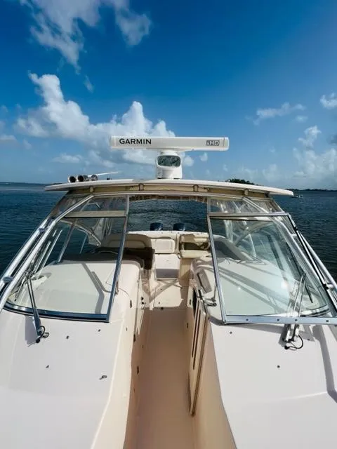 Slide: The Image of 2014 Grady-White Freedom 335 boat on calm water under a clear blue sky. - 20