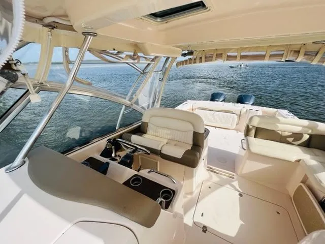 Slide: The Image of 2014 Grady-White Freedom 335 boat interior with seating and ocean view. - 21