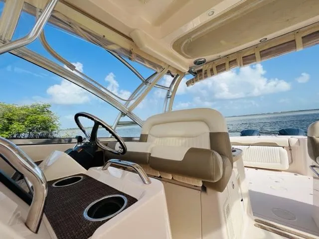 Slide: The Image of 2014 Grady-White Freedom 335 boat interior with steering wheel and seating, ocean view. - 25