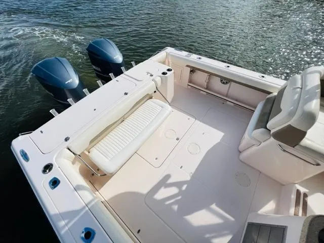 Slide: The Image of 2014 Grady-White Freedom 335 boat with dual outboard motors on water. - 28