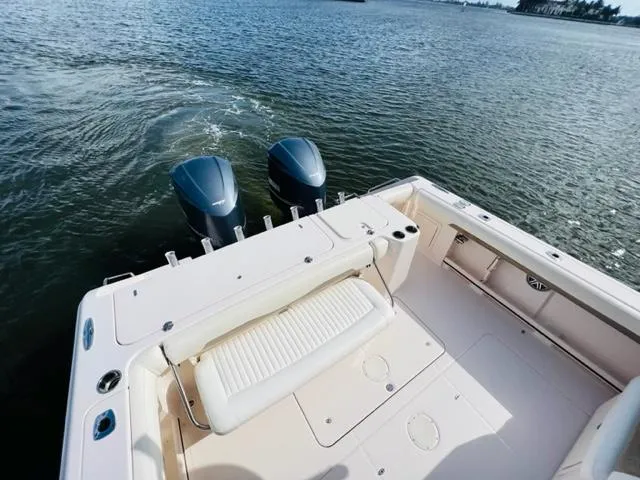 Slide: The Image of 2014 Grady-White Freedom 335 boat with twin outboard motors on water. - 29