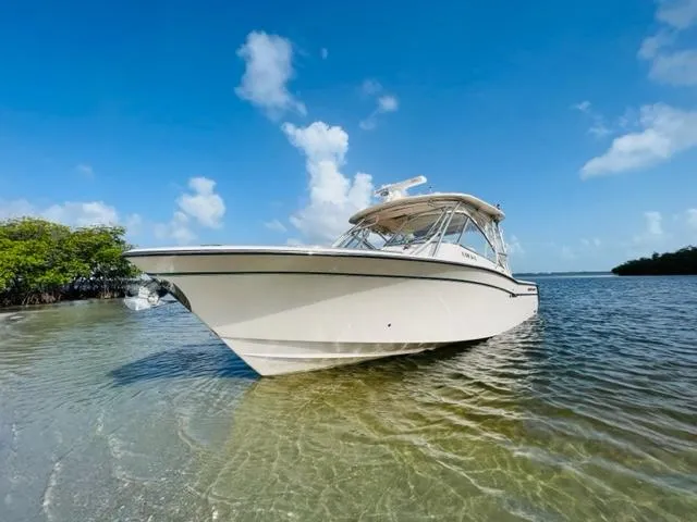 Slide: The Image of 2014 Grady-White Freedom 335 boat in shallow water on a sunny day. - 3