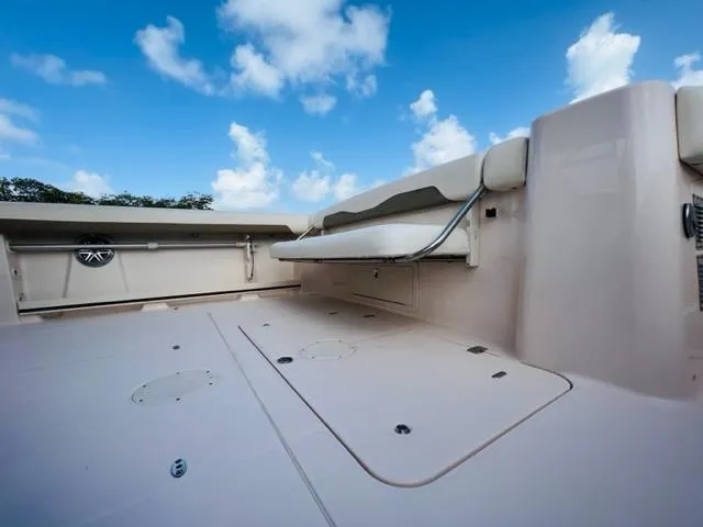 Slide: The Image of 2014 Grady-White Freedom 335 boat deck with foldable seating under a blue sky. - 30