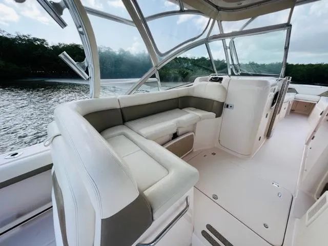 Slide: The Image of 2014 Grady-White Freedom 335 boat interior with white seating and scenic water view. - 32