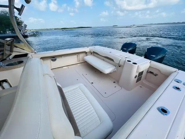 Slide: The Image of 2014 Grady-White Freedom 335 boat interior with seating, ocean view, and twin outboard motors. - 34