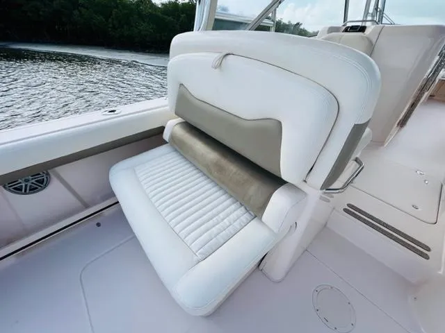 Slide: The Image of 2014 Grady-White Freedom 335 boat seat with white and beige upholstery. - 35