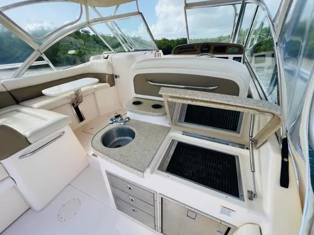 Slide: The Image of 2014 Grady-White Freedom 335 boat interior with kitchenette and seating area. - 37