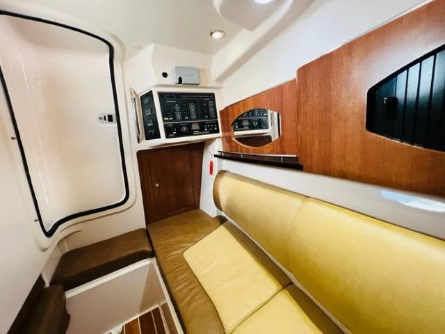 Slide: The Image of Interior cabin of a 2014 Grady-White Freedom 335 boat with control panel and seating. - 44