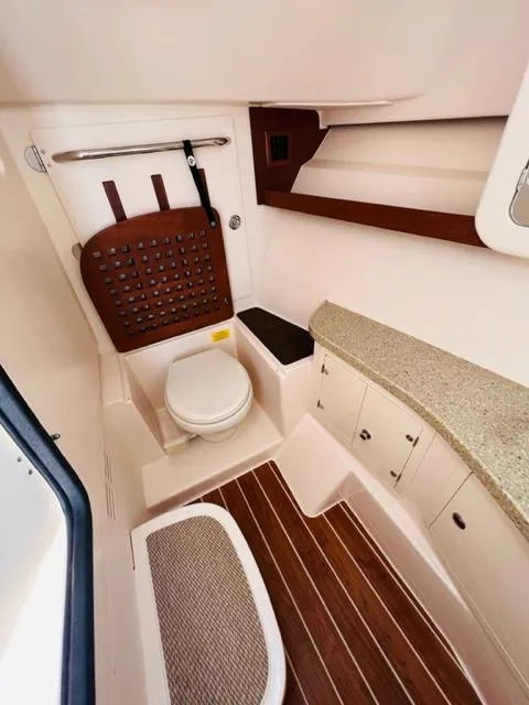 Slide: The Image of 2014 Grady-White Freedom 335 boat bathroom with toilet and storage. - 47