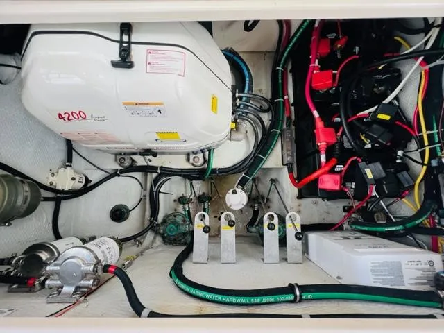 Slide: The Image of Engine compartment of a 2014 Grady-White Freedom 335 boat with various mechanical components. - 48