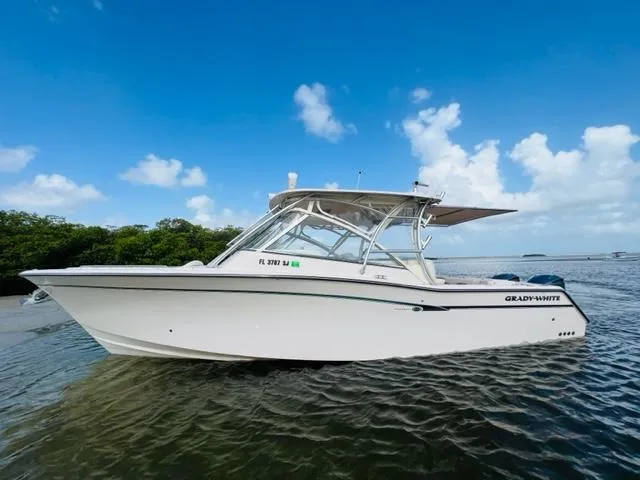 Slide: The Image of 2014 Grady-White Freedom 335 boat on calm water with blue sky background. - 6